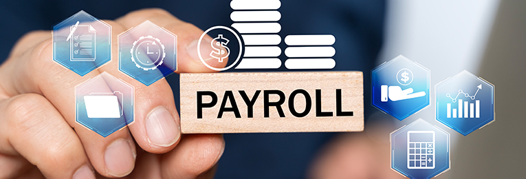 we can see a person holding a rectangle shape wooden cube with payroll text written on it in his hand